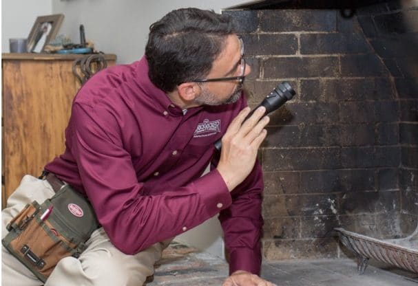 person inspecting fireplace