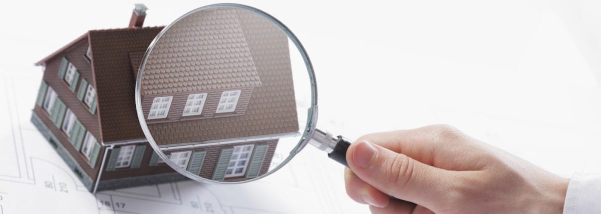 Inspecting Home With Magnifying Glass